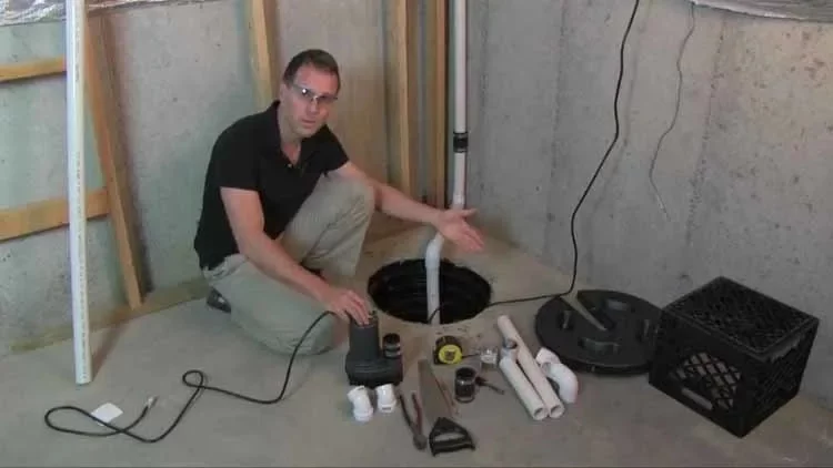 A Man Installing The Wayne ESP25 Battery Backup Sump Pump
