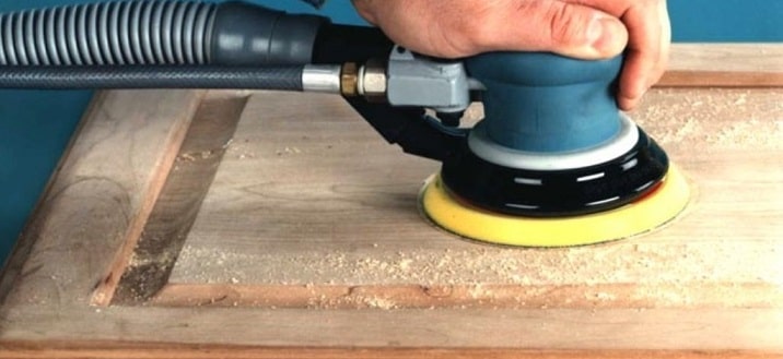 A Man Sanding Wooden Door